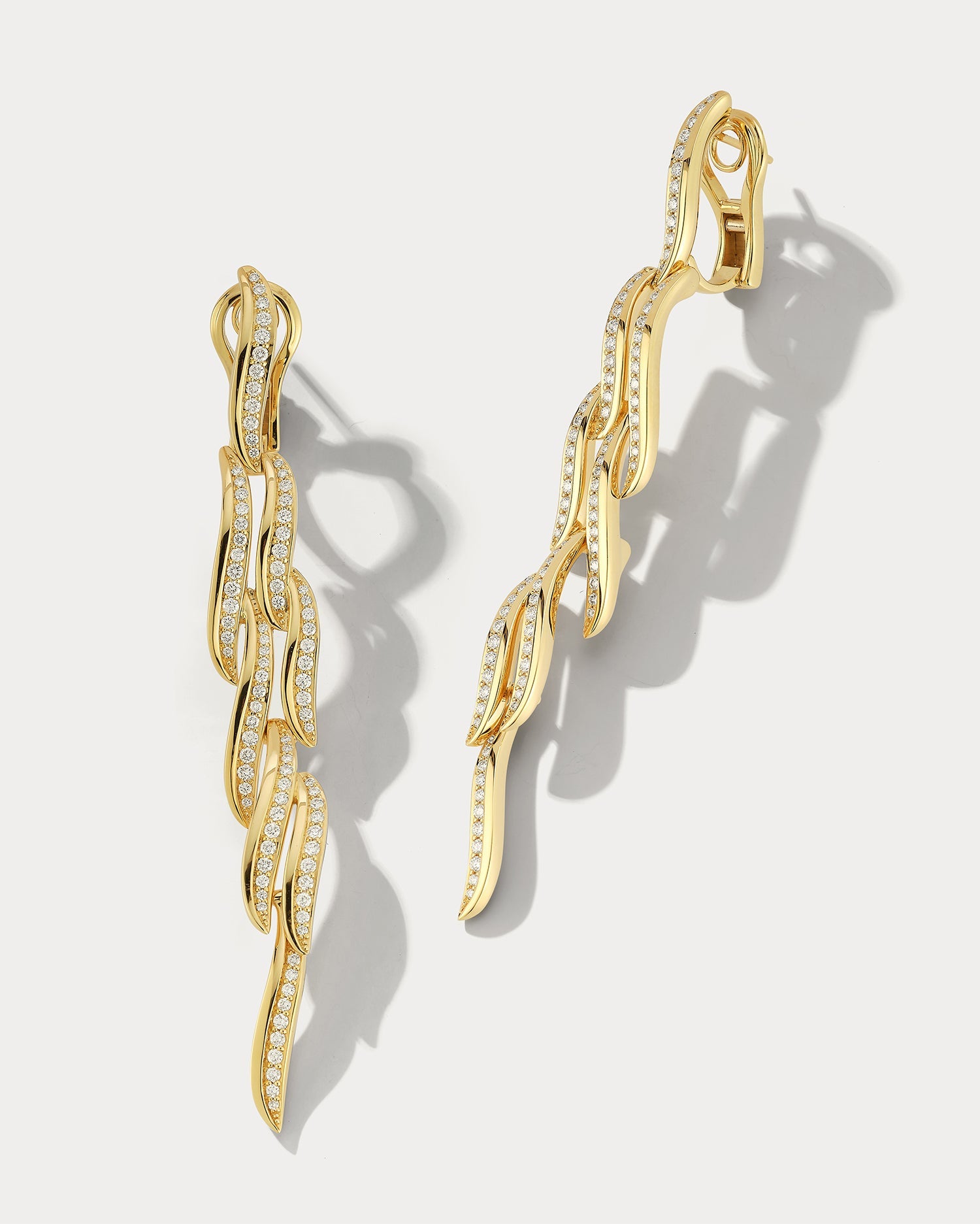 Ammrada Drop Wave Earring featuring a sleek, flowing wave design in gold-tone metal, perfect for elegant jewelry styling.