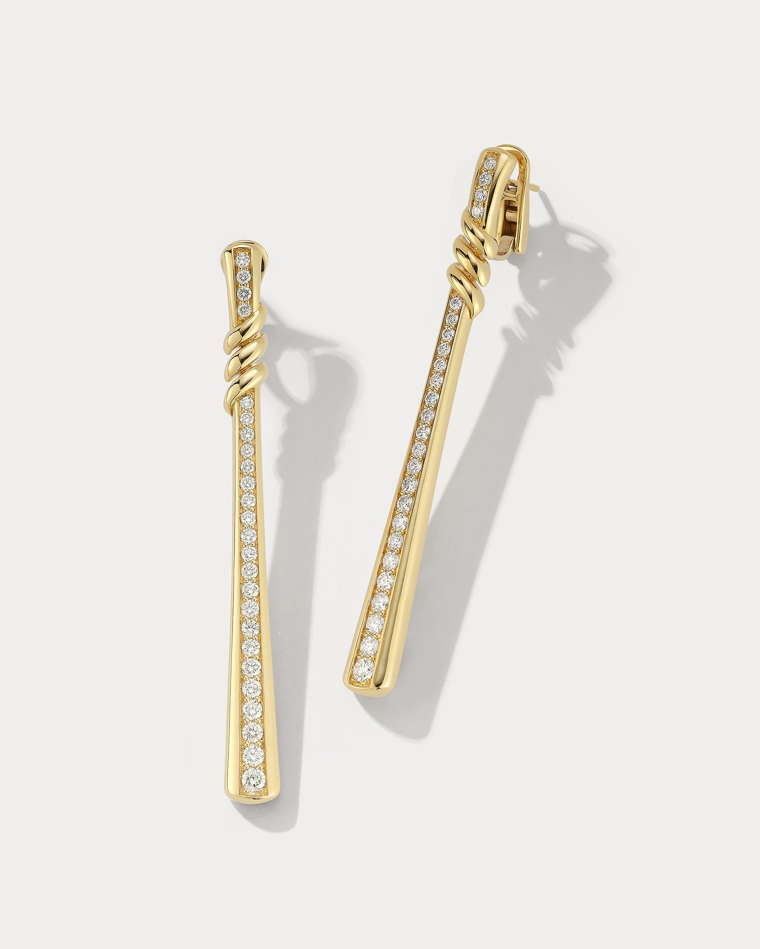 Drop yellow gold and diamond earring by Ammrada featuring a sleek design with sparkling diamonds on a yellow gold setting.