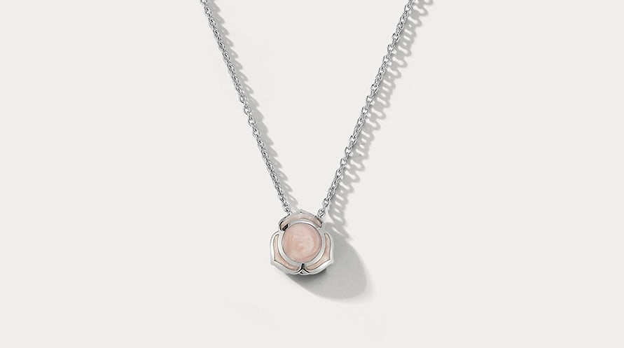 Ammrada Heartnote white gold and pink ceramic pendant necklace with a delicate heart-shaped design.
