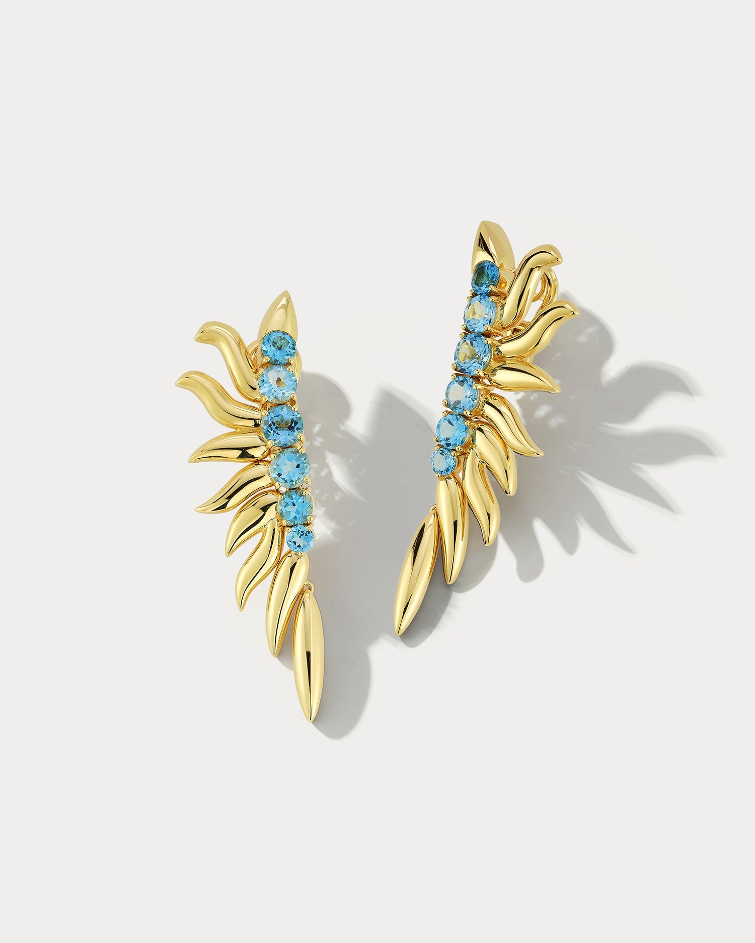 Ammrada blue topaz yellow gold earrings featuring a teardrop-shaped blue topaz gemstone set in polished yellow gold.