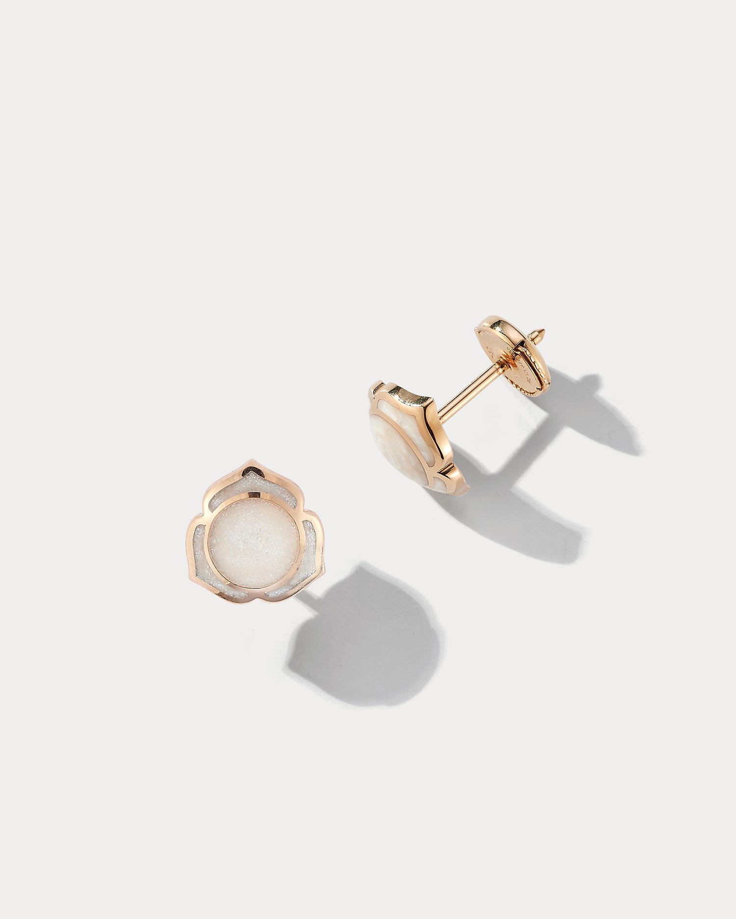 Ammrada Heartnote rose gold and pearl ceramic earstuds featuring delicate heart-shaped designs and elegant pearl accents.