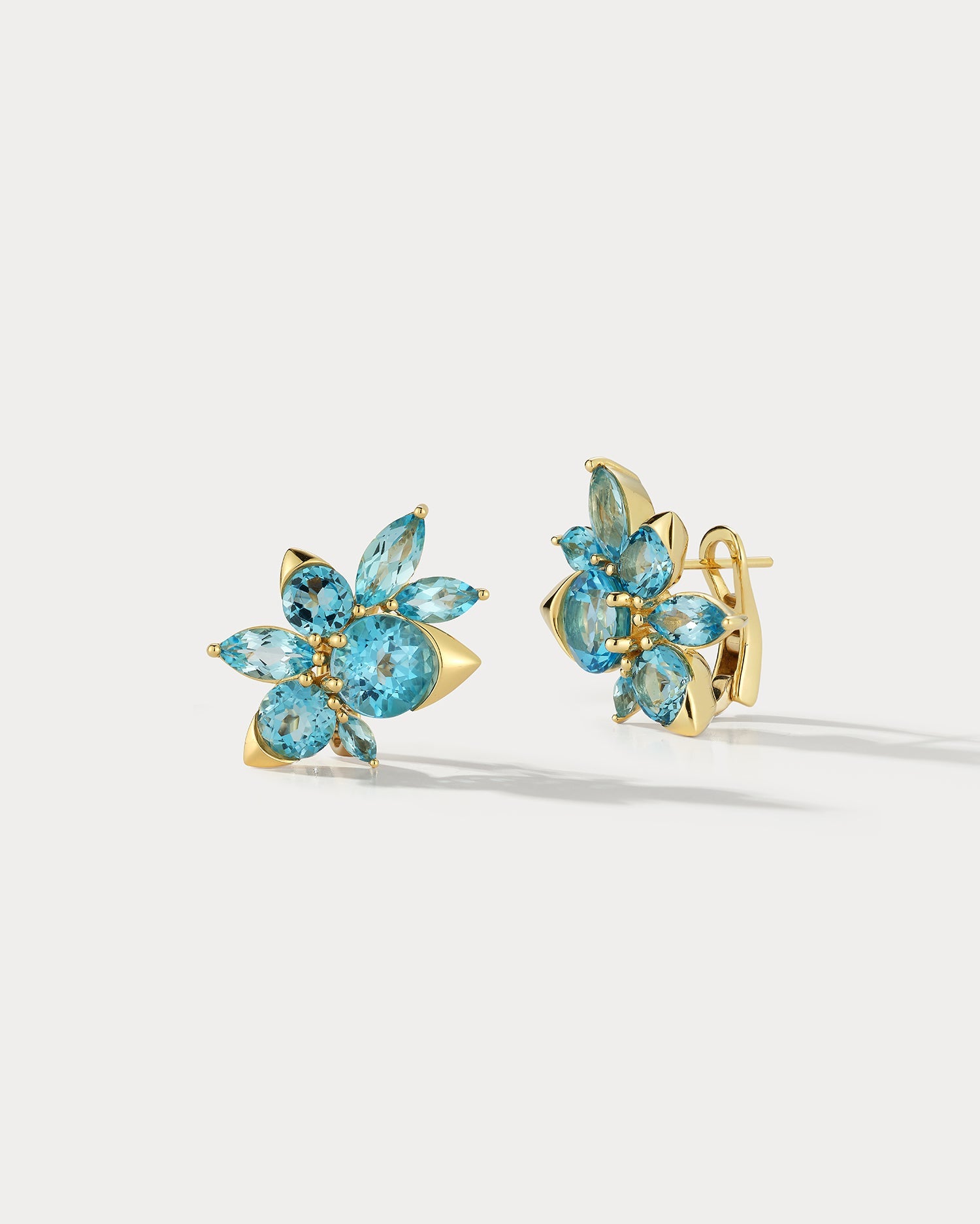 Ammrada Blue Topaz Cluster Earrings featuring sparkling blue topaz gemstones in a clustered design on elegant earring settings.