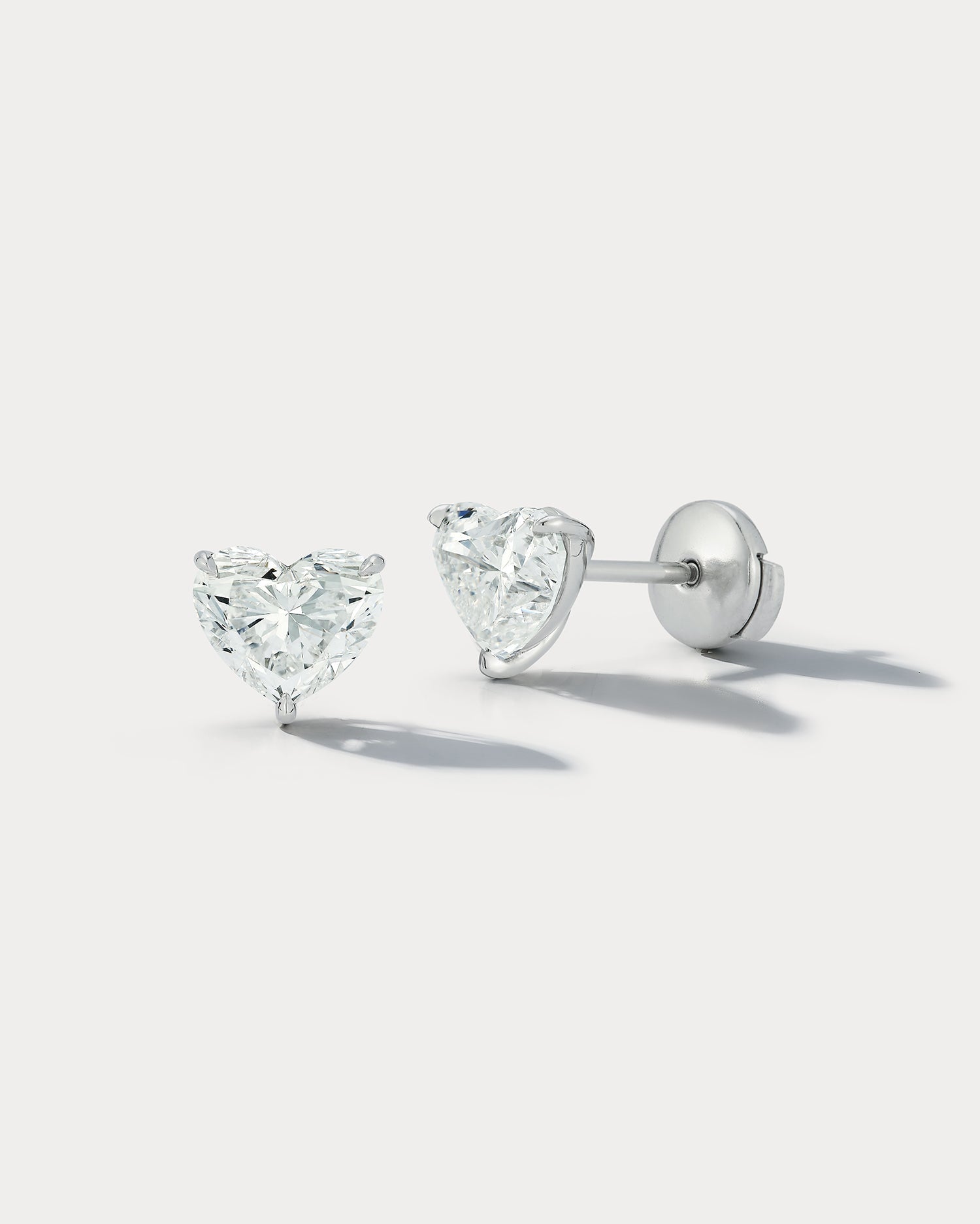 Ammrada heart-shaped diamond stud earrings featuring sparkling diamonds set in a classic earring design.
