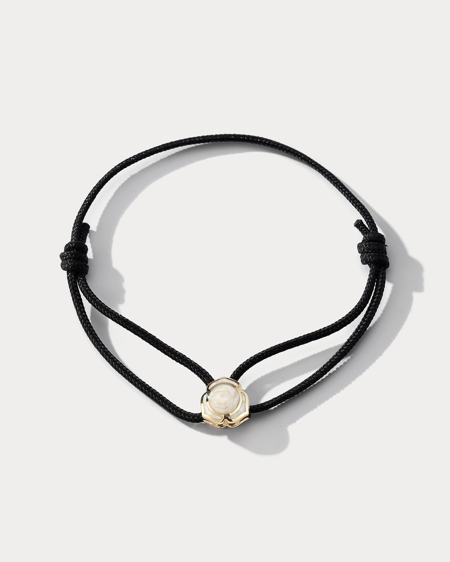Yellow gold bracelet with pearl accents featuring a heart-shaped note charm, by Ammrada.