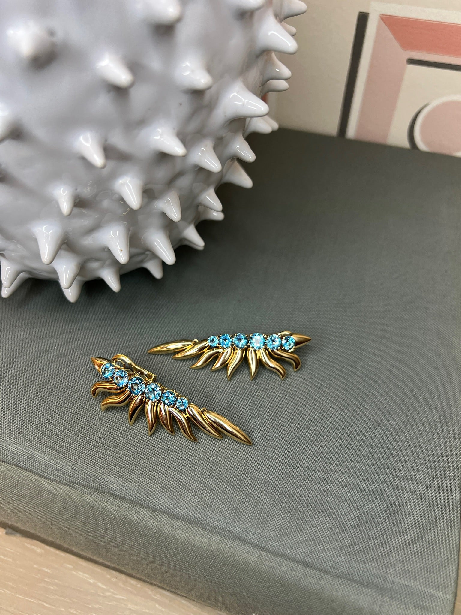 Ammrada blue topaz yellow gold earrings featuring a classic earring design with sparkling blue topaz stones and polished gold settings.
