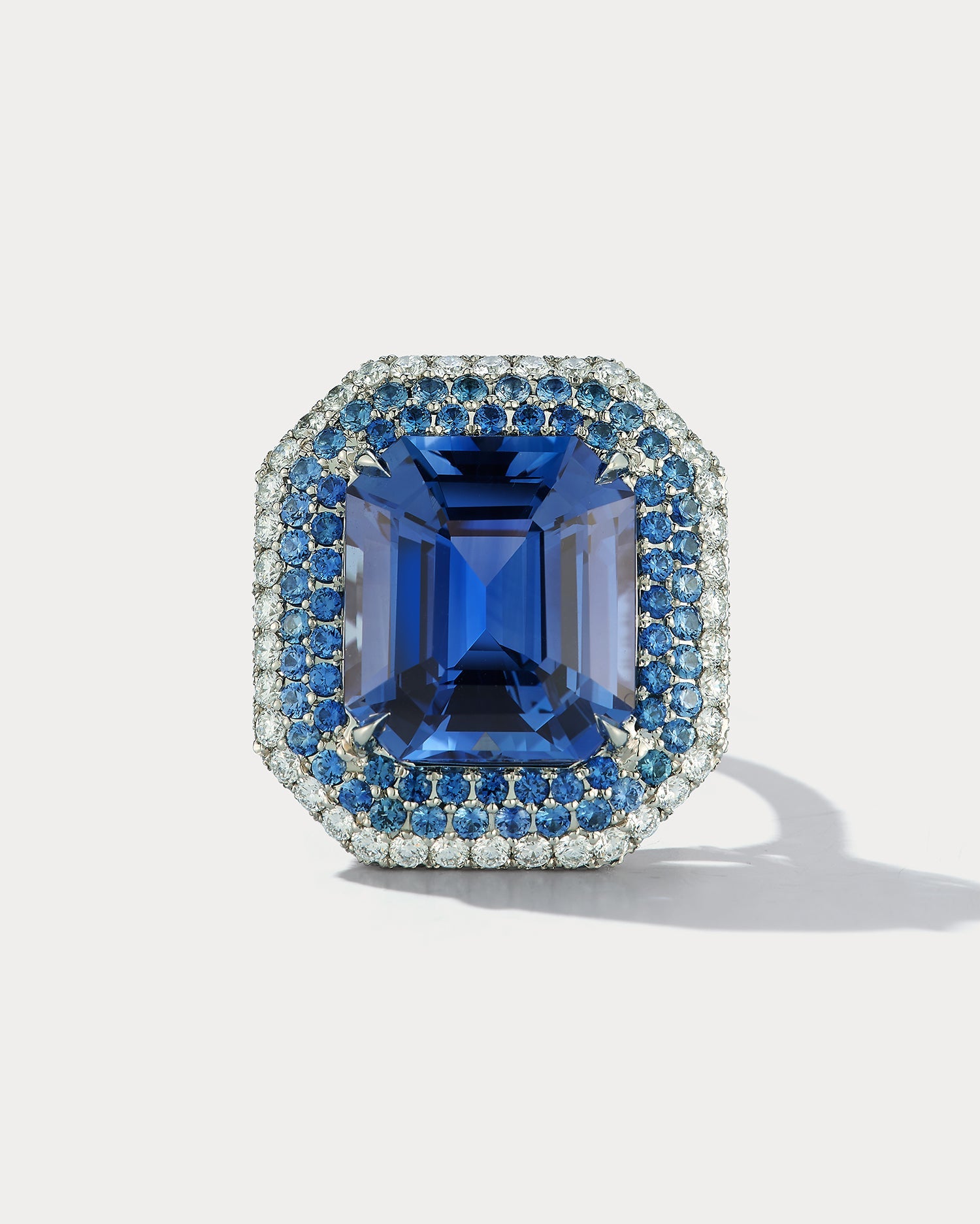 Ammrada 12ct emerald-cut sapphire ring featuring a striking blue sapphire center stone with a sleek band.