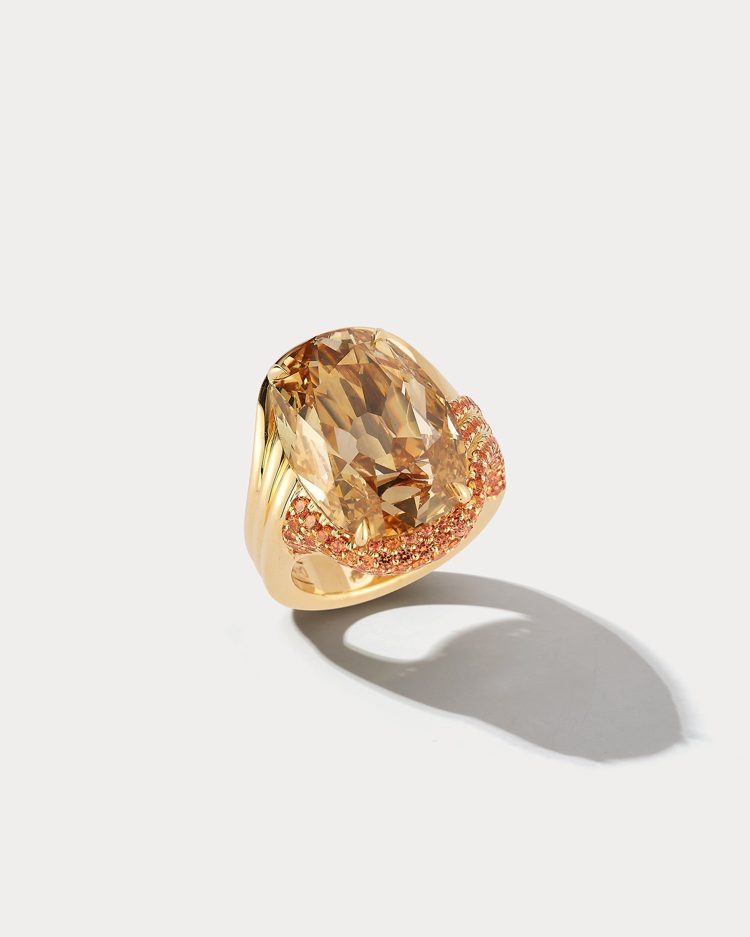 Ammrada 12.35ct diamond ring featuring 1.55ct orange sapphires with a sleek band and sparkling gemstone details.