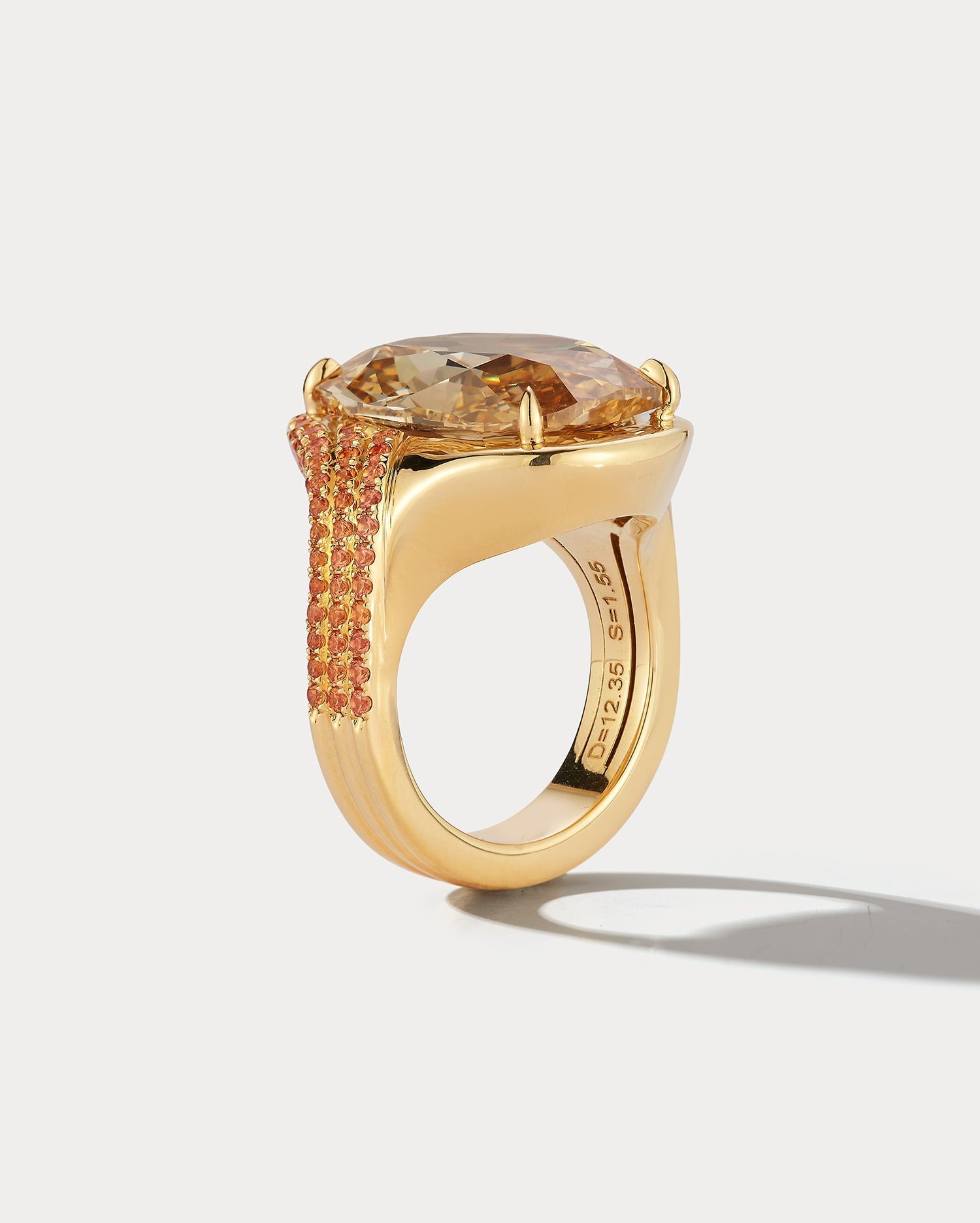 Ammrada 12.35ct diamond ring with 1.55ct orange sapphires, featuring sparkling diamonds and vibrant orange gemstones on a luxurious band.