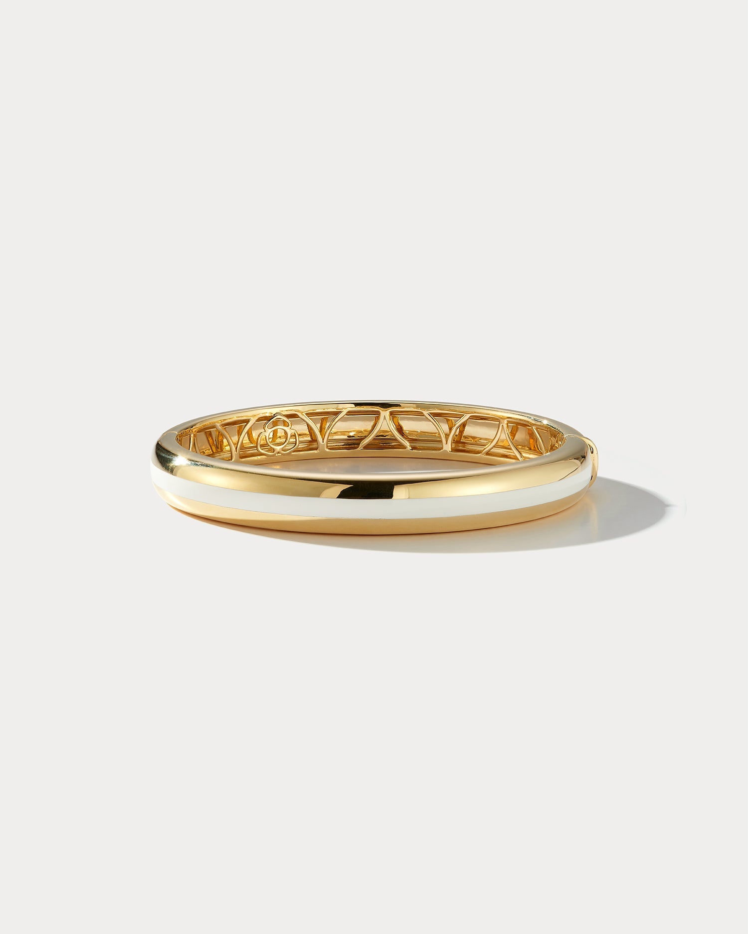 Wide white ceramic and yellow gold bangle by Ammrada, showcasing smooth ceramic surface with elegant gold accents.