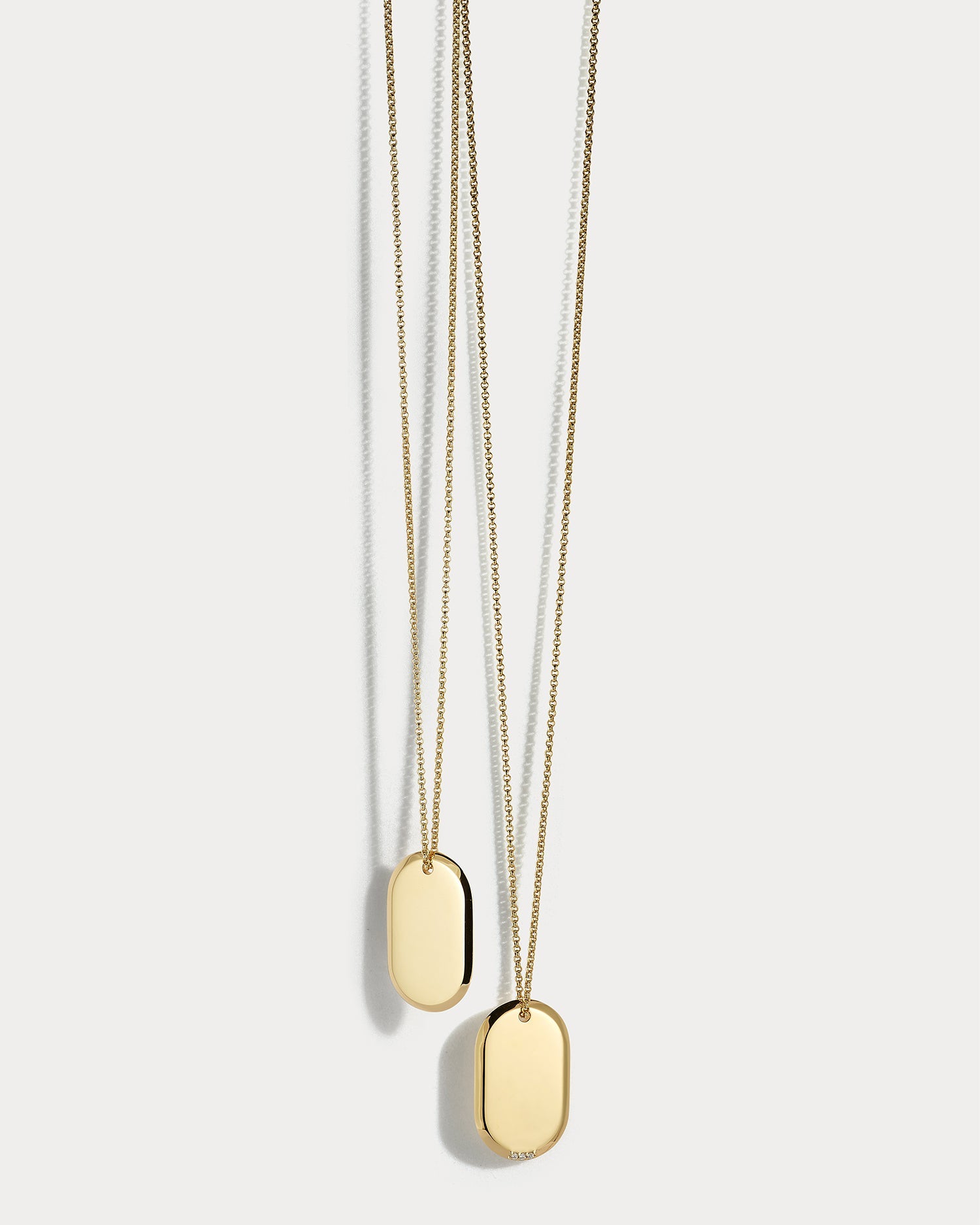 18k yellow gold dog tag necklace with diamond accents from Ammrada, featuring a sleek, polished pendant design.