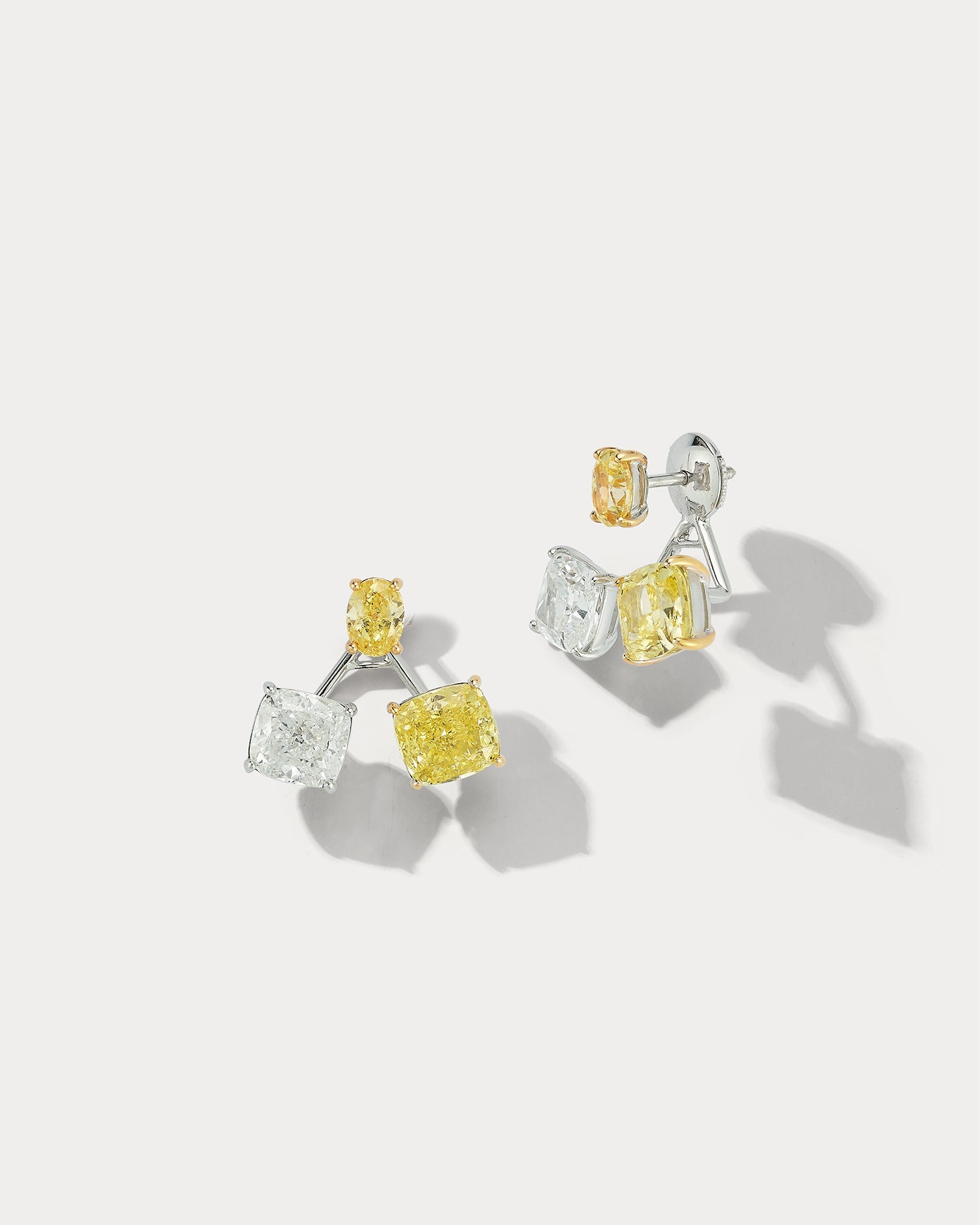 Ammrada GIA-Certified yellow and white diamond earrings with 18K white gold setting, showcasing vivid yellow and sparkling white diamonds.