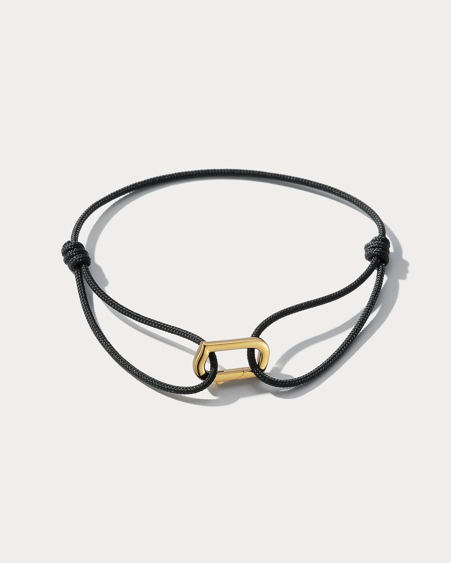 Ammrada Infinity bracelet with Japanese silk in black, featuring 18K yellow gold accents, showcasing elegant craftsmanship.