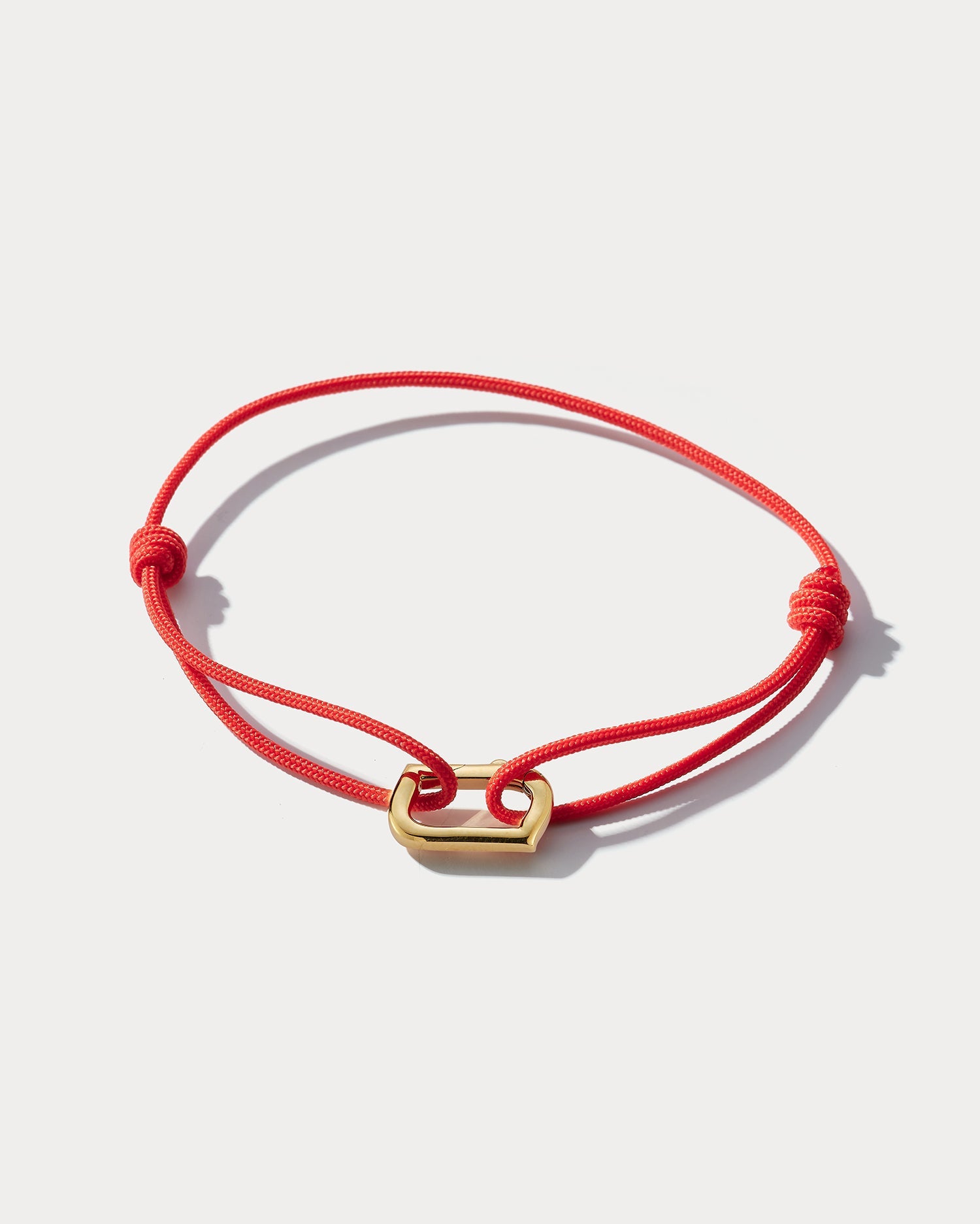 Ammrada infinity bracelet with black or red Japanese silk and 18K yellow gold accents, elegant jewelry for sophisticated style.