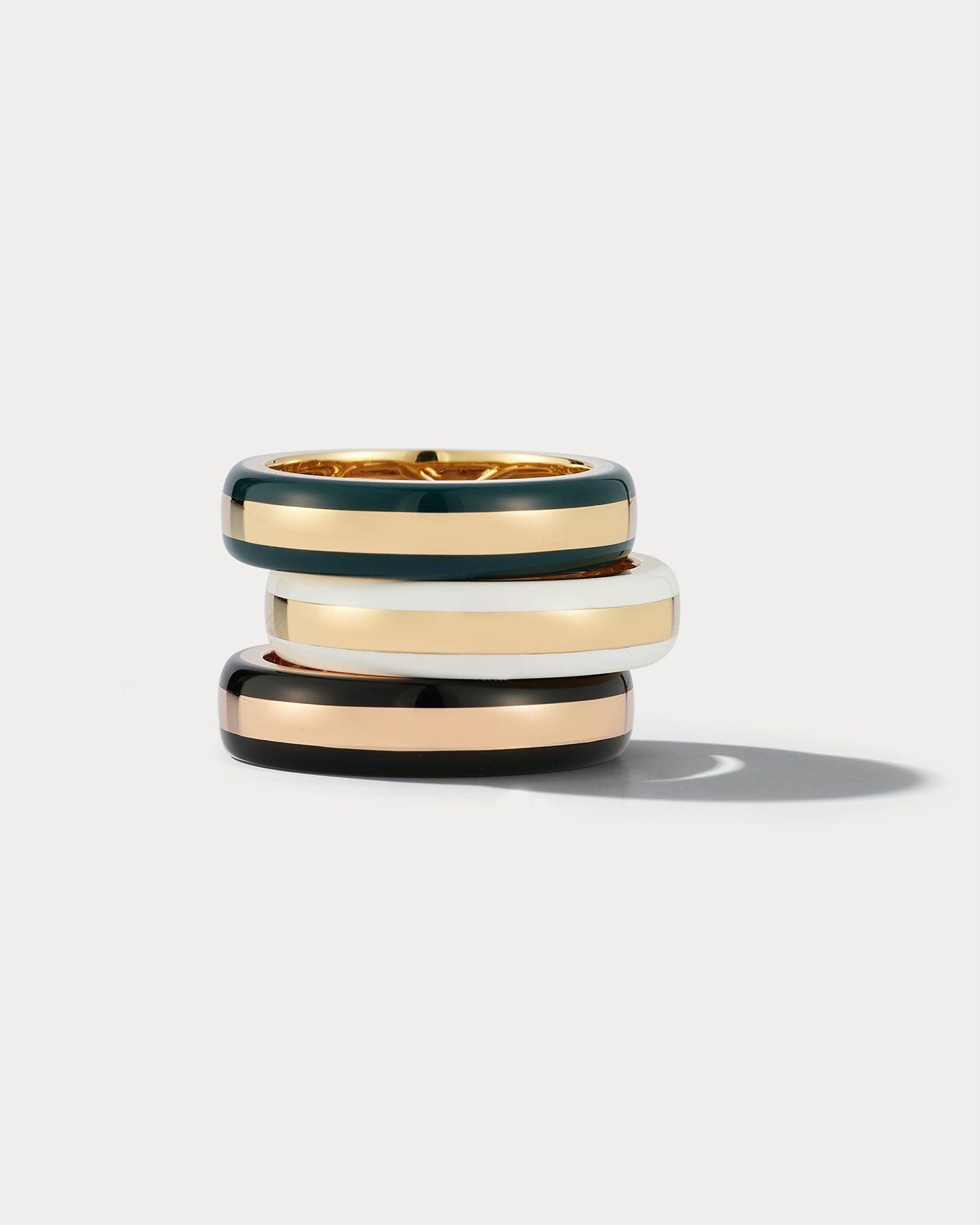 Rose gold and black ceramic ring by Ammrada featuring a sleek, modern design with smooth finish and contrasting colors.