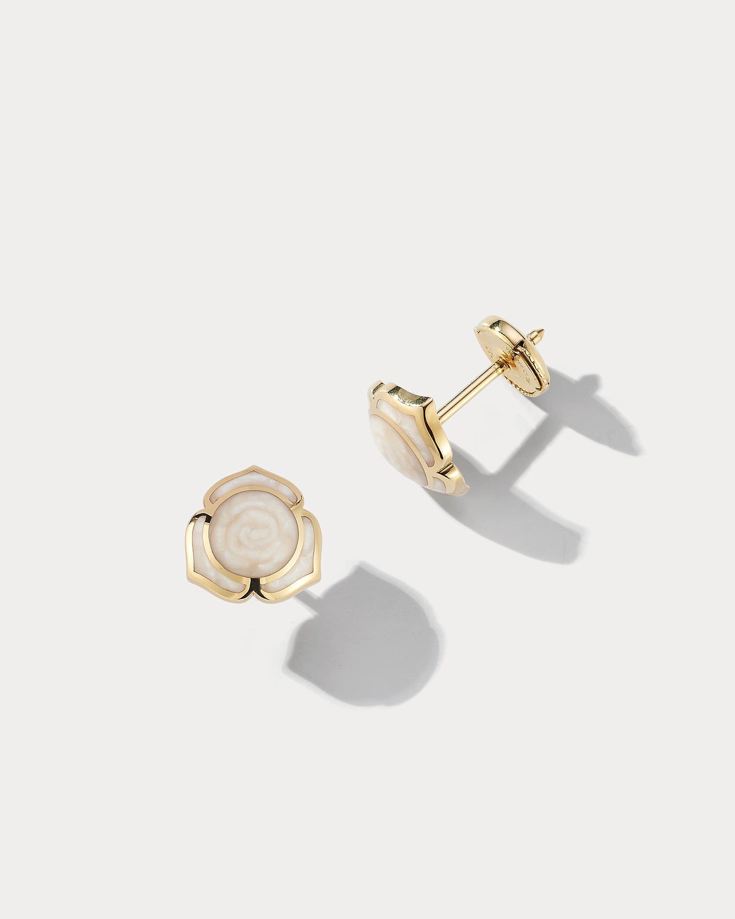 Ammrada Heartnote yellow gold and pearl ceramic earstuds featuring small, elegant heart-shaped design with shiny gold and pearl accents.