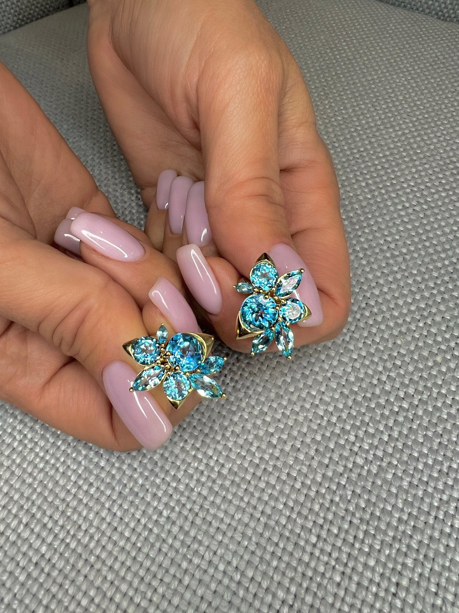 Blue Topaz Cluster Earrings by Ammrada featuring sparkling blue topaz stones arranged in a delicate cluster design.