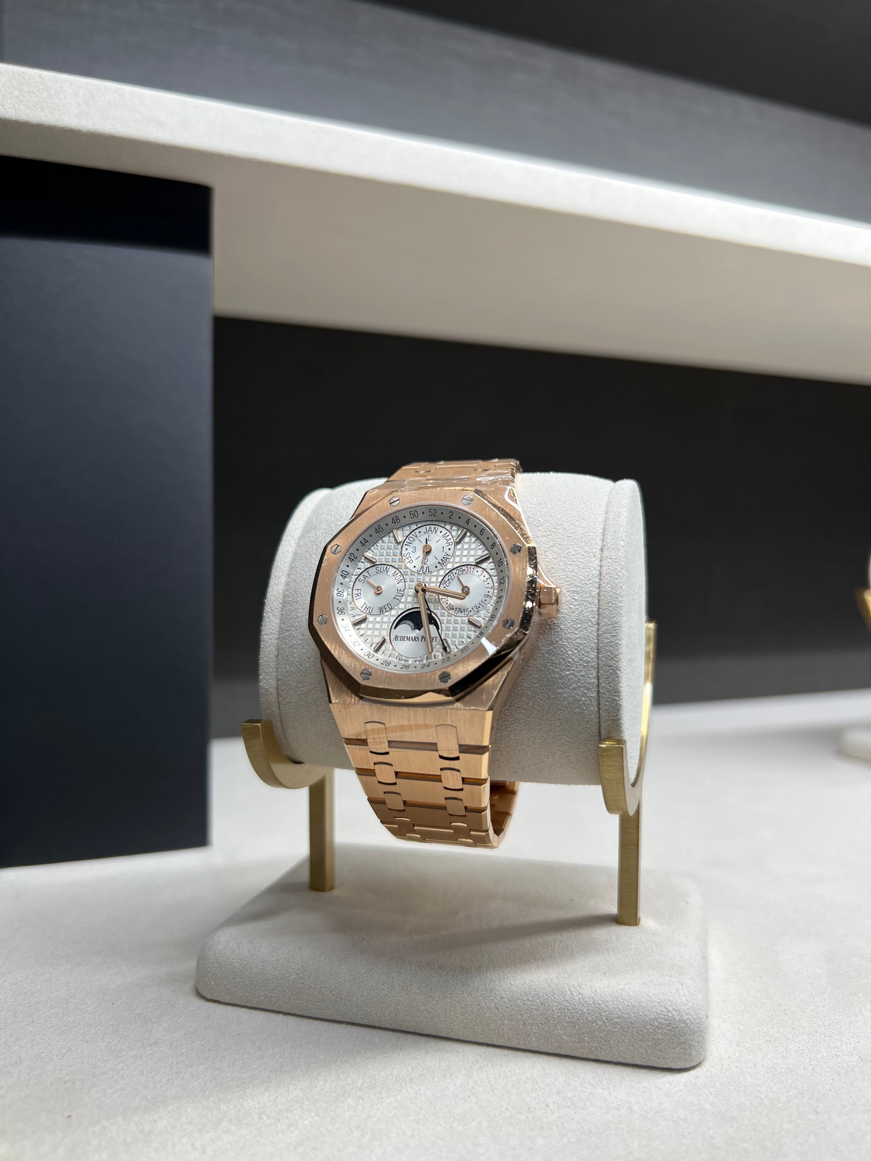 Audemars Piguet Royal Oak Perpetual Calendar watch with gold case, black dial, and leather strap, displayed on a white background.